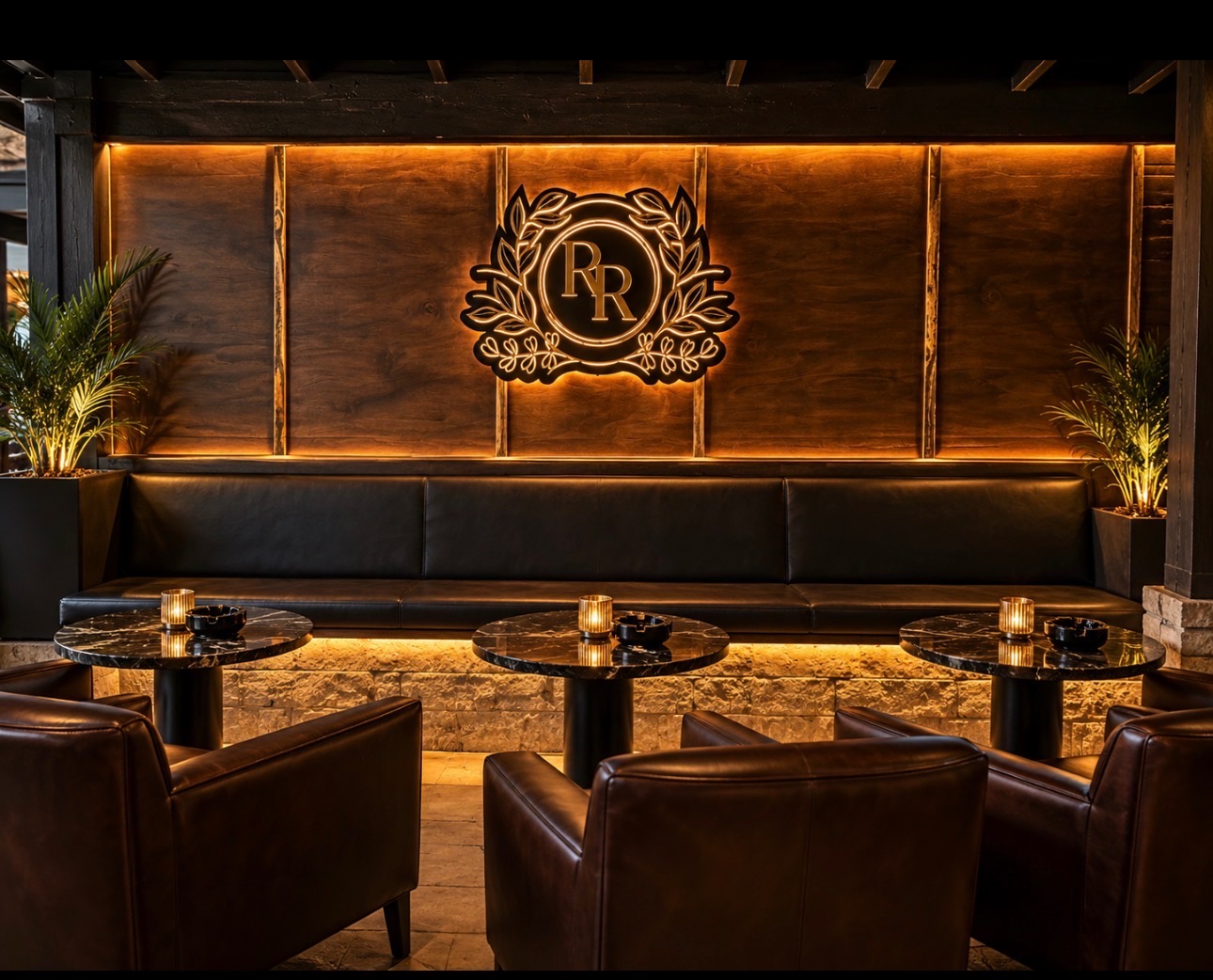 The Reserve Room RR crest illuminated on the walnut lounge wall